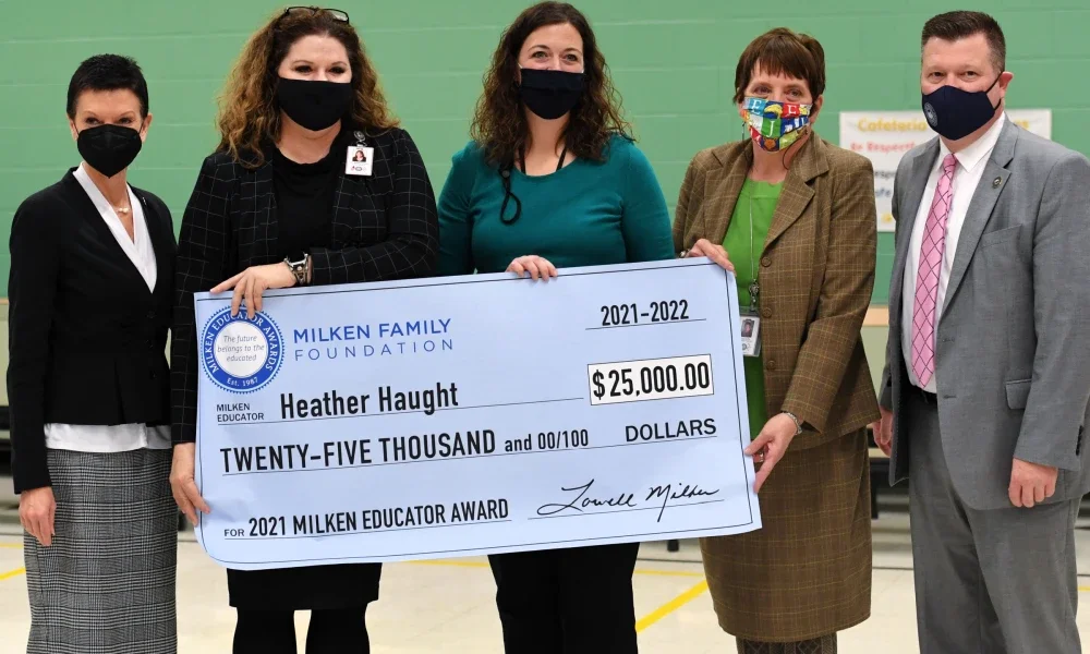 Heather Haught presented Milken Award Check, also pictured Jane Duffy, Shelby Hanes, and Clayton Burch