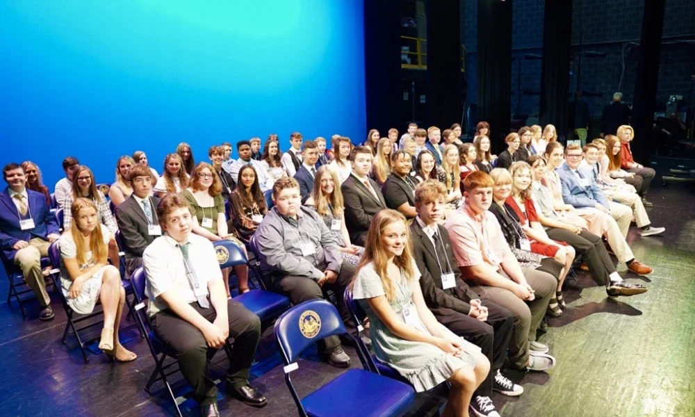 Group of Golden Horseshoe winners sit on the stage at the Knighting Ceremony