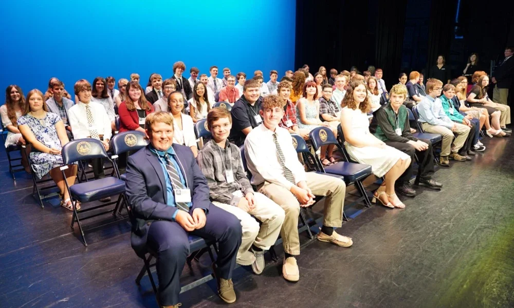 Group of Golden Horseshoe winners sit on the stage at the Knighting Ceremony