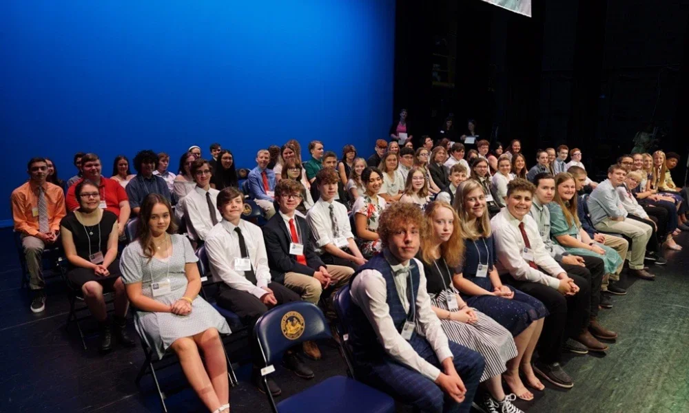 Group of Golden Horseshoe winners sit on the stage at the Knighting Ceremony