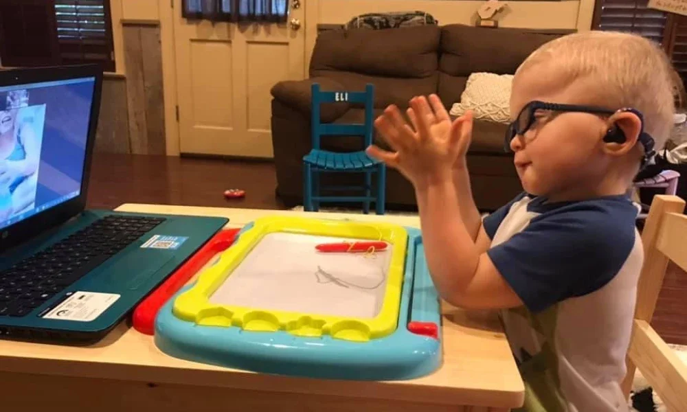 Eli signing alligator in virtual speech therapy. 