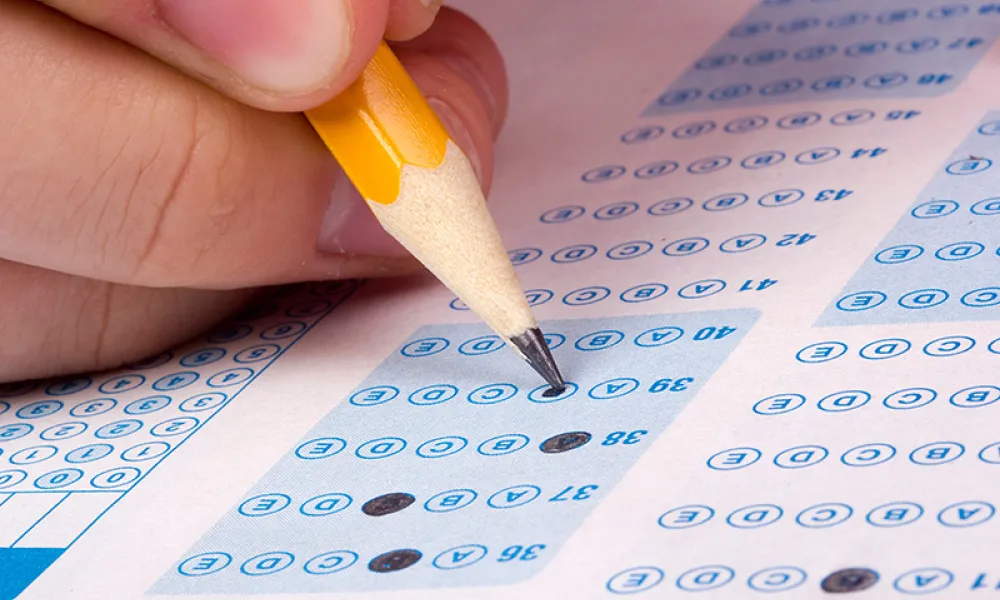 Image of a test sheet with a pencil filling in the bubbles