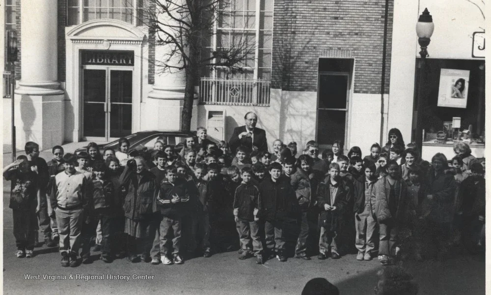 Rockefeller gathered with children outside of a library on Temple Street in Hinton, WV.