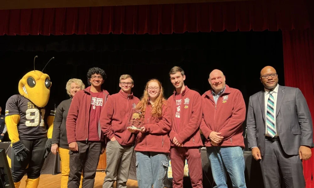 Pictured are students holding a first place trophy.