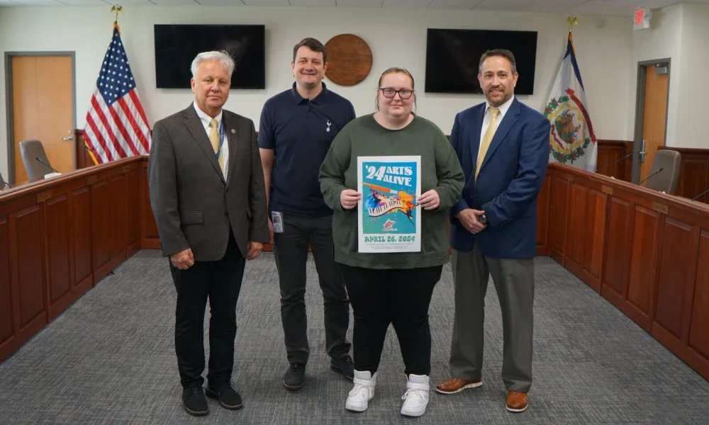 (L-R): PK-12 Academic Support Coordinator Timothy James, Communications Program Specialist Tom Pickens, Robert C. Byrd High School Senior Alexis Brewer and Assistant Superintendent of PK-12 Adult Instruction and Career Engagement Clinton Burch pose for a photo with the 2024 Arts Alive poster.