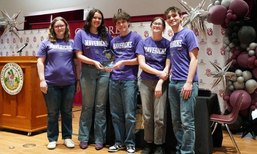 James Monroe High School students posing with a second-place trophy.