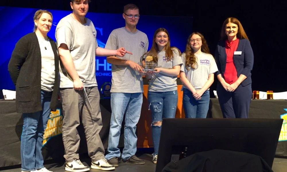 Westside High School Team 1 students posing for a group photo while holding a second-place 2024 Academic Showdown trophy.