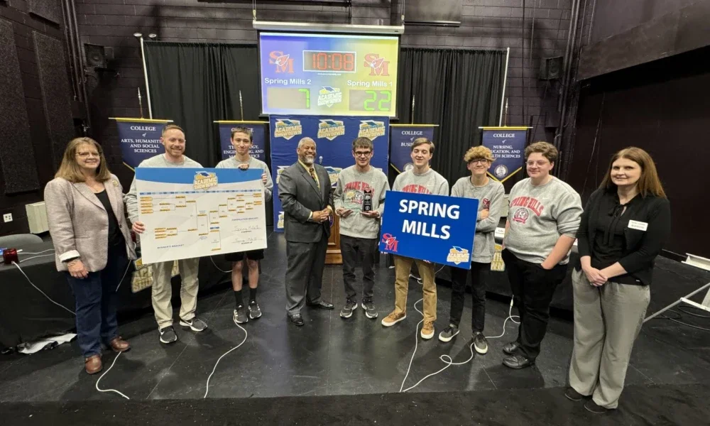 Students posing for photo with first-place trophy