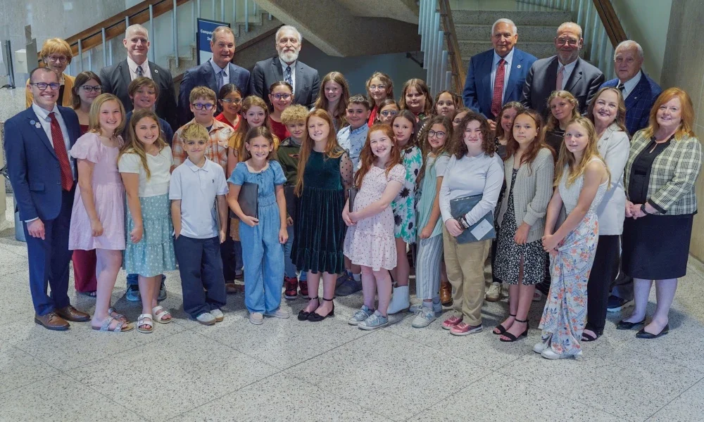 Seth Skiles, West Virginia Board of Education members, and students posing for a photo.