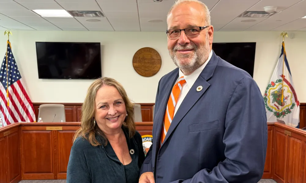 Nancy White and Paul Hardesty holding a meeting gavel.