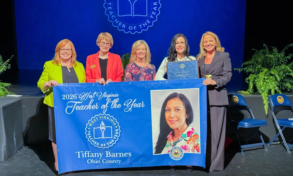Five people holding a banner. 2026 West Virginia Teacher of the Year Tiffany Barnes.