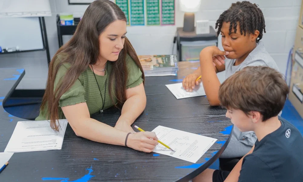 A teacher assisting a student.
