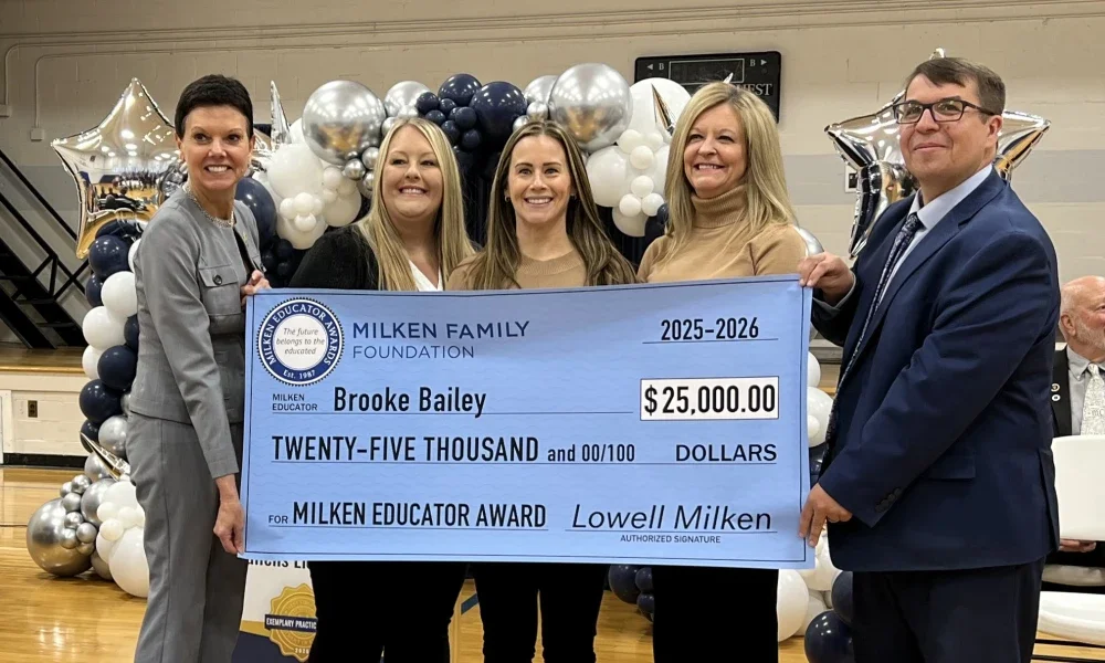 Brooke Bailey, Michele Blatt, and others holding a prize check for $25,000.