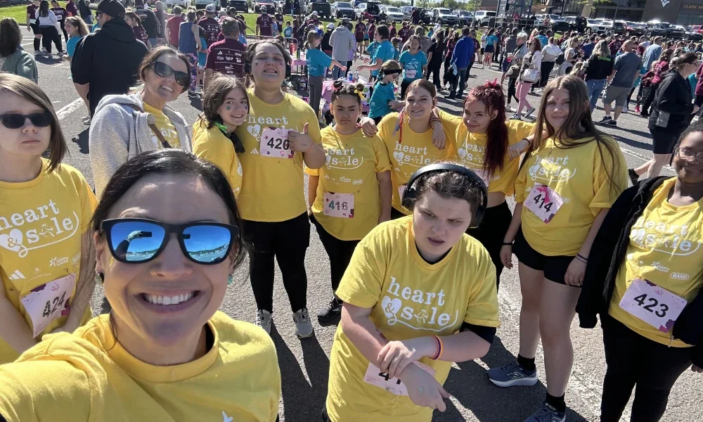 Tiffany Barnes smiling along with other people.