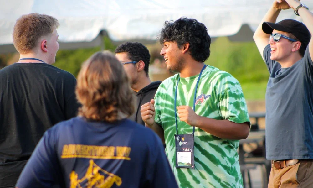 People smiling and standing together in a group.