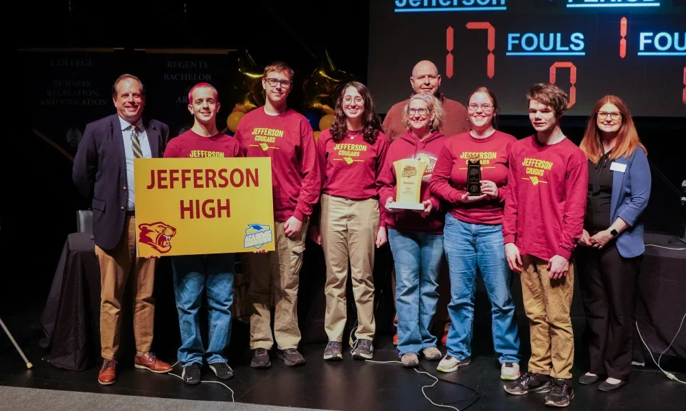 Members of Jefferson High School's Academic Showdown team holding a trophy.