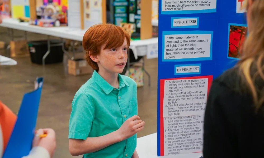 A student presenting his project to judges.