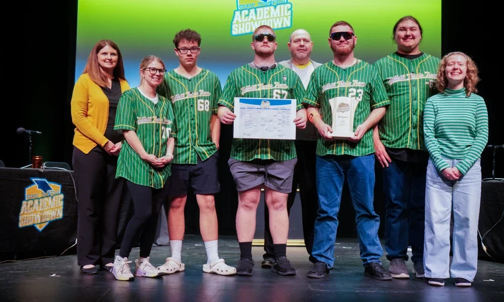 Members of Braxton County's 2026 Academic Showdown team smiling while holding a trophy.