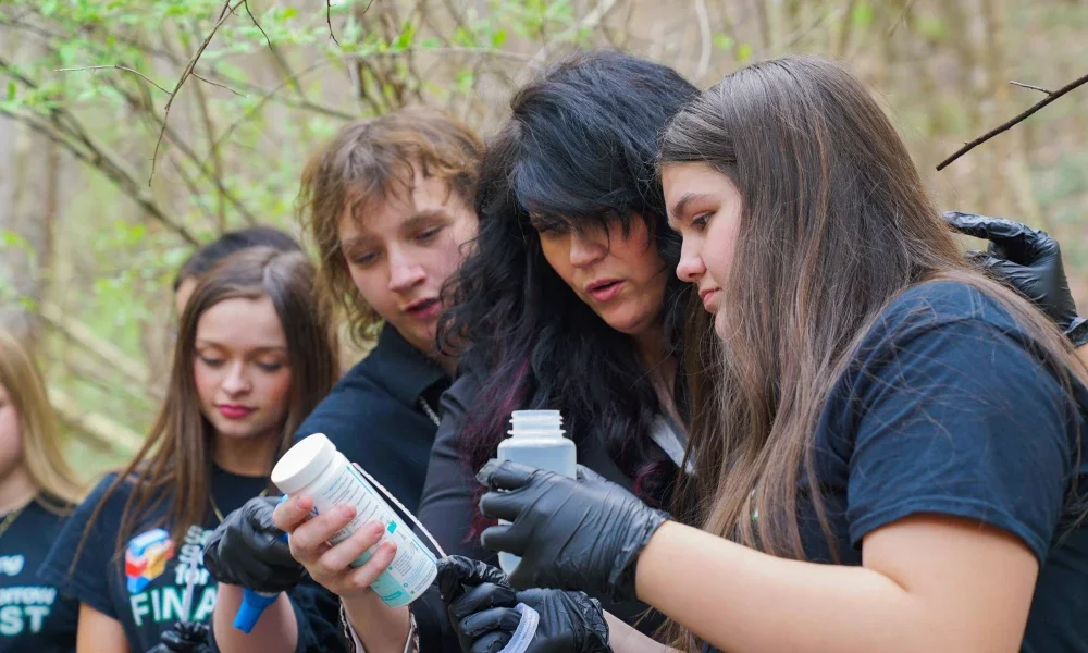 Brittany Miller and student testing a water sample.