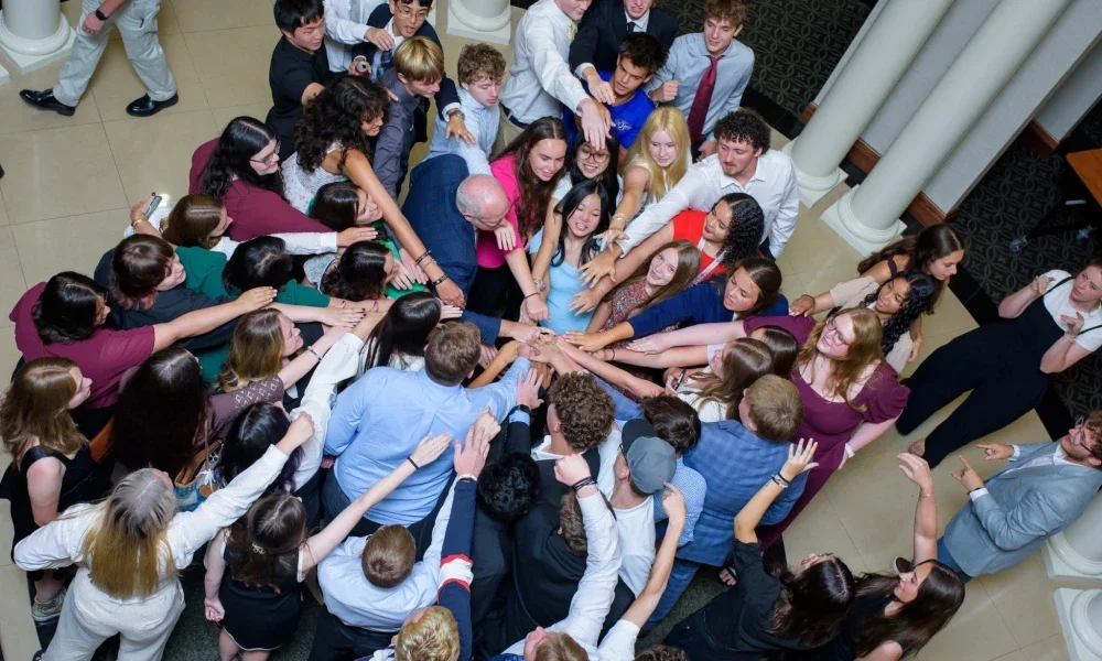Several people joining their hands together. 