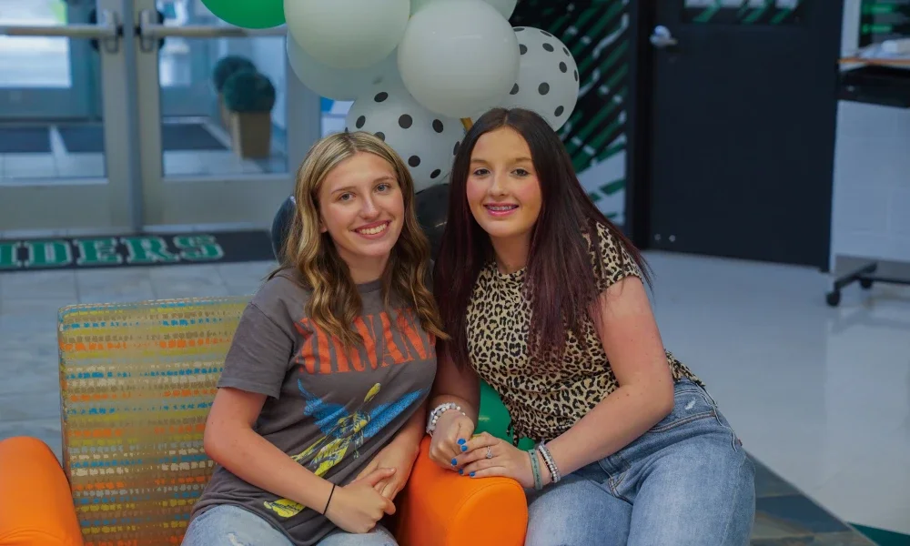 Two students smiling. 