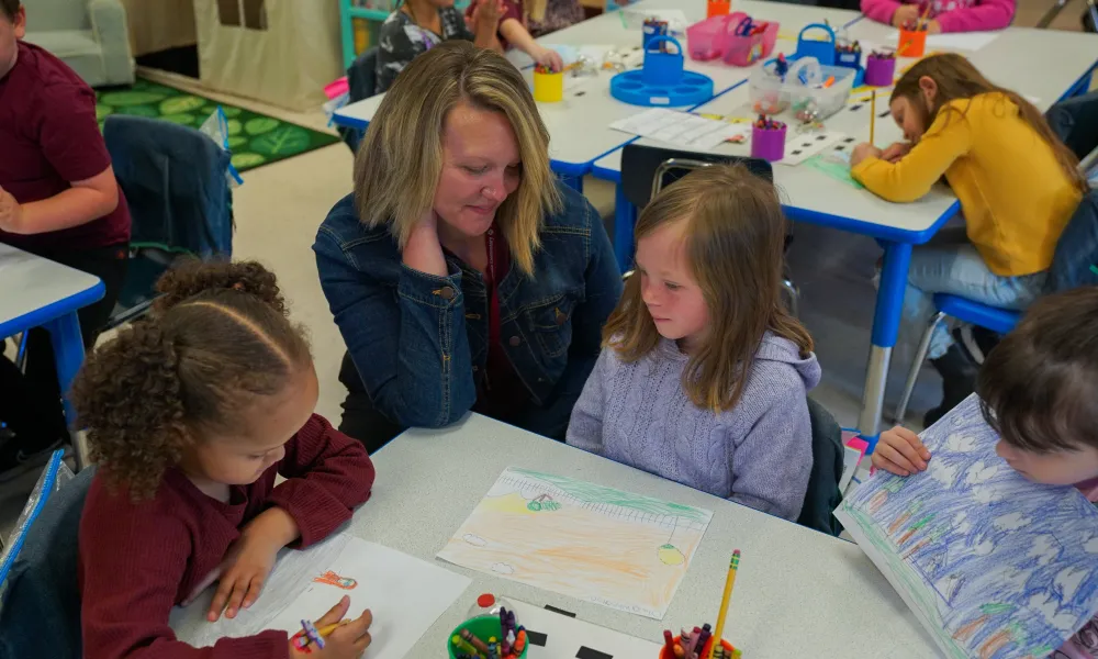 A teacher looking at a student's work. 