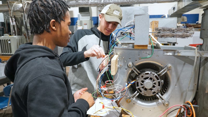 People working on HVAC wiring.