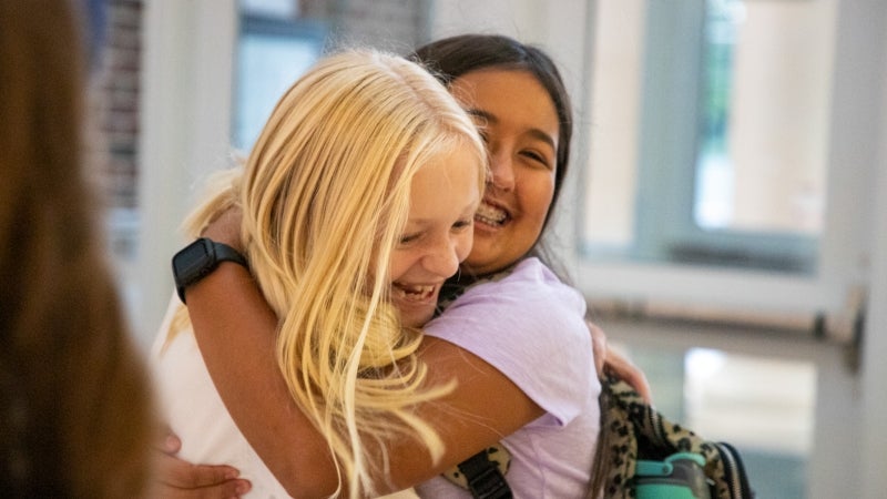 Two students hugging.