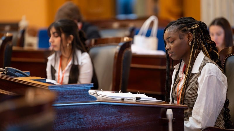 Youth Leadership Association (YLA) students sit at senate desks.