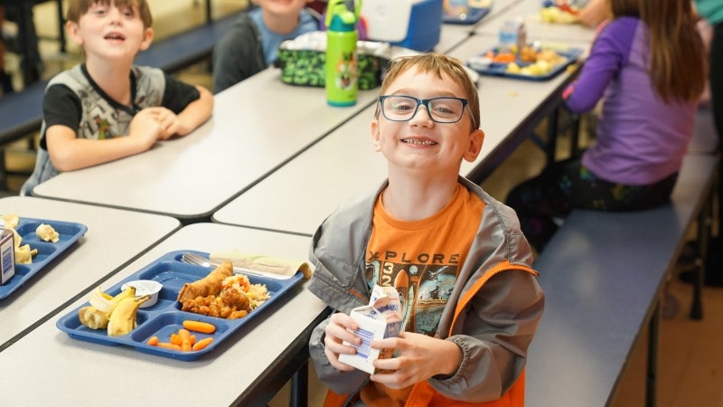 Students eating lunch in a school cafeteria.