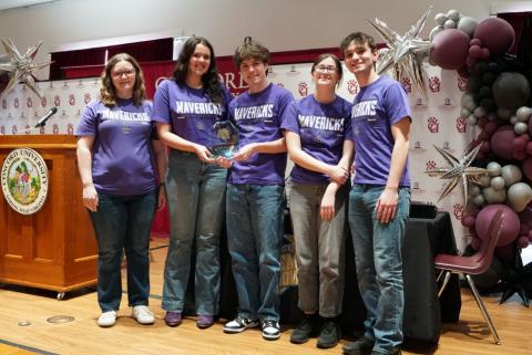 James Monroe High School students posing with a second-place trophy.