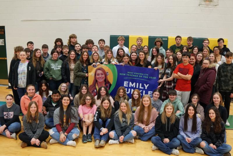 Group of students taking a photo with teacher Emily Dunkle. 
