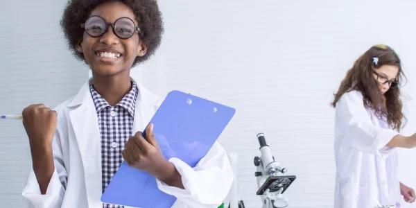 Young boy studying science in classroom at school