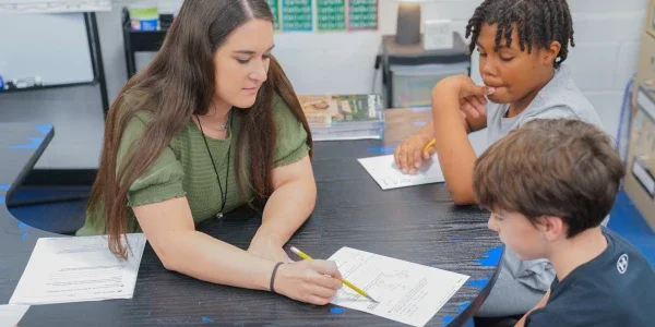 A teacher assisting a student.