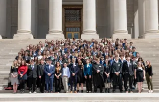 Hundreds of Youth Leadership Association students stand on the capitol stairs.