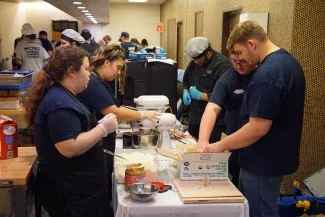 Students working at a culinary station.
