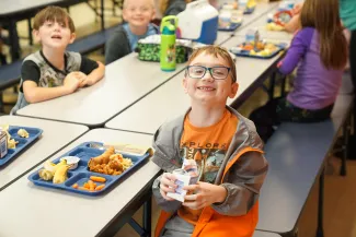 Students eating lunch in a school cafeteria.
