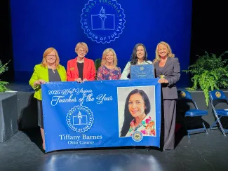 Five people holding a banner. 2026 West Virginia Teacher of the Year Tiffany Barnes.