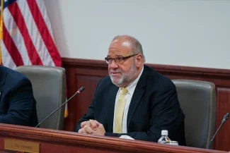 Paul Hardesty speaking into microphone