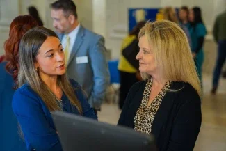 Michele Blatt and a student talking to one another.