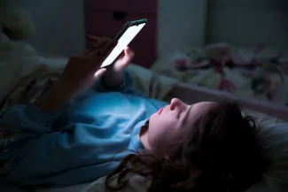 Child using a smartphone unattended.