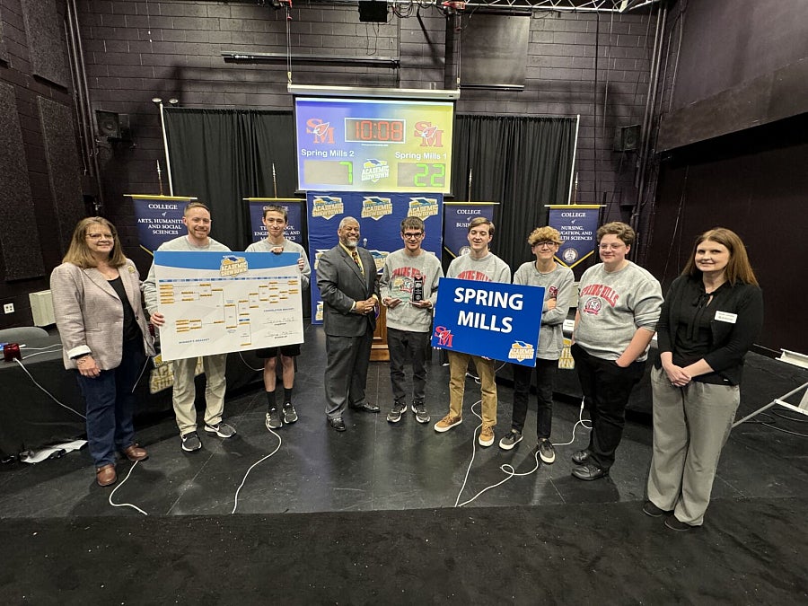 Students posing for photo with first-place trophy
