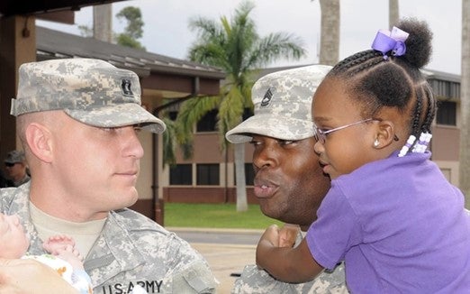Two active members of the military great each other's families.
