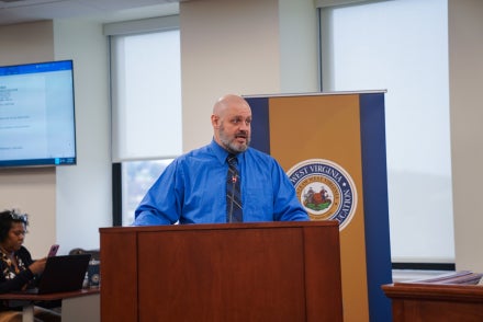 Brandon Kelley speaking from a podium.