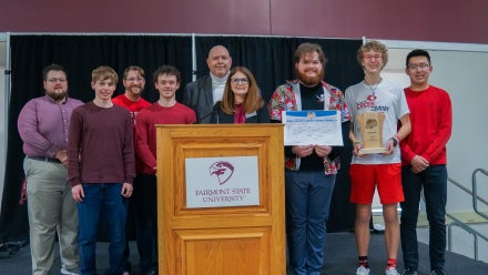 Members of Bridgeport High School's Academic Showdown team holding a trophy.