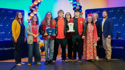 Members of Weir High School's Academic Showdown team holding a trophy.