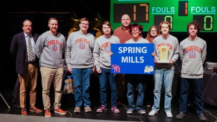 Members of Spring Mills High School's Academic Showdown team holding a trophy.