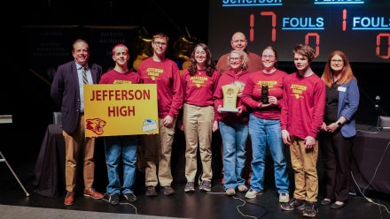 Members of Jefferson High School's Academic Showdown team holding a trophy.