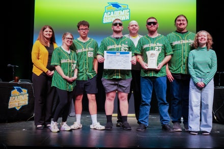 Members of Braxton County's 2026 Academic Showdown team smiling while holding a trophy.