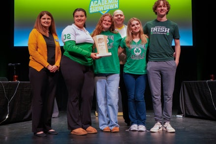 Members of Charleston Catholic High School's 2026 Academic Showdown team smiling while holding a trophy.